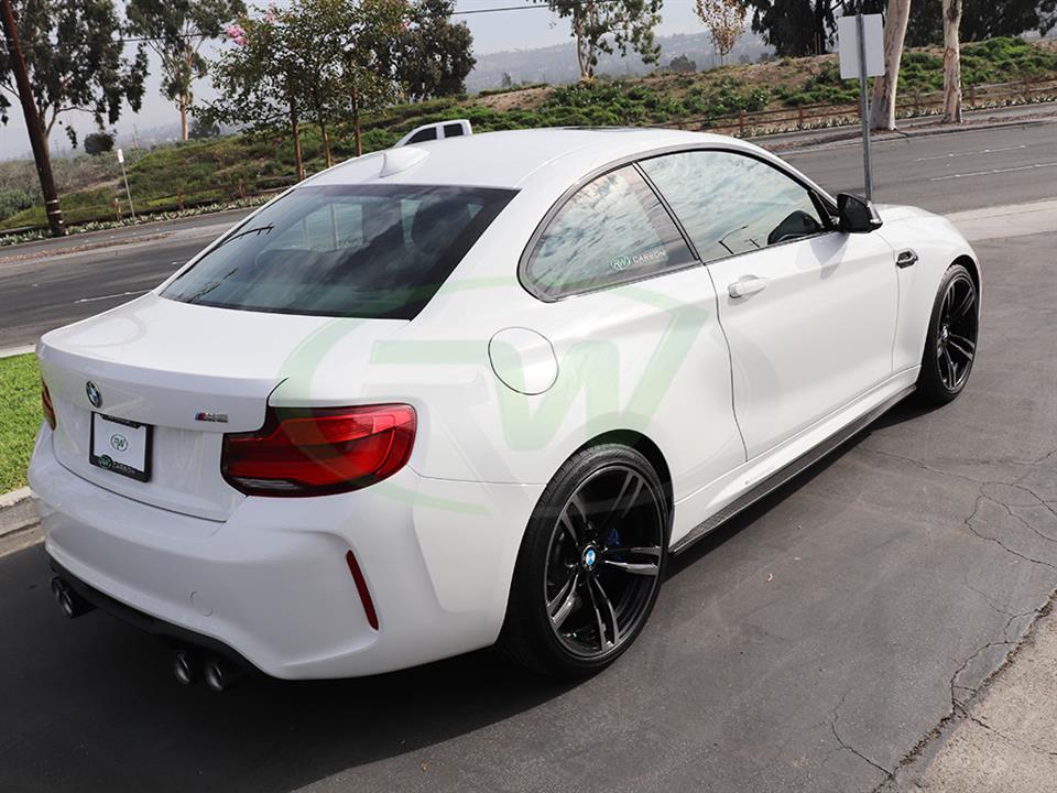 White BMW M2 with carbon fiber side skirt extensions