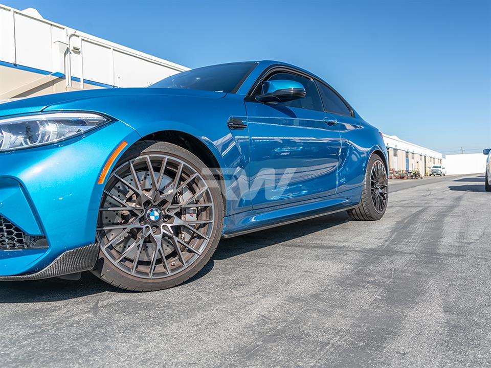 Blue BMW M2 competition with carbon fiber side skirts