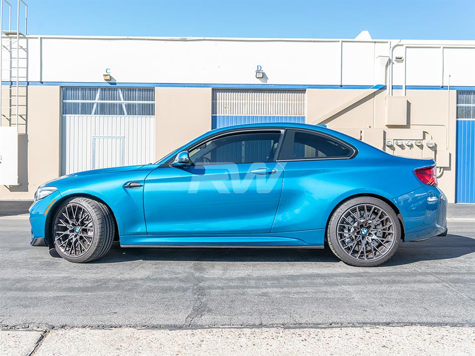 Blue BMW M2 competition with carbon fiber side skirts