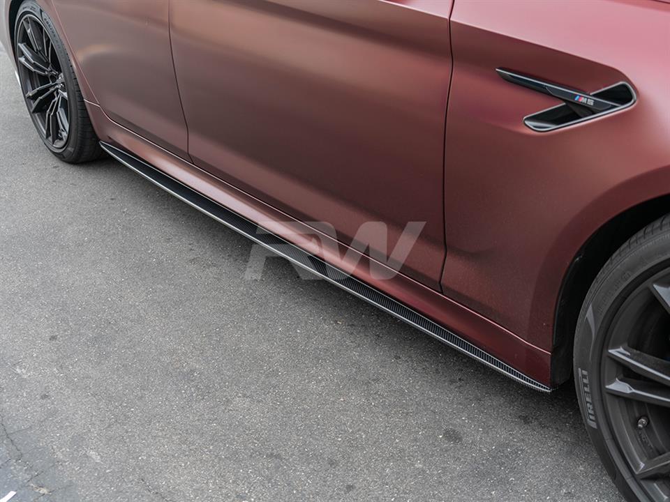 Red BMW F90 with performance style carbon fiber side skirt extensions