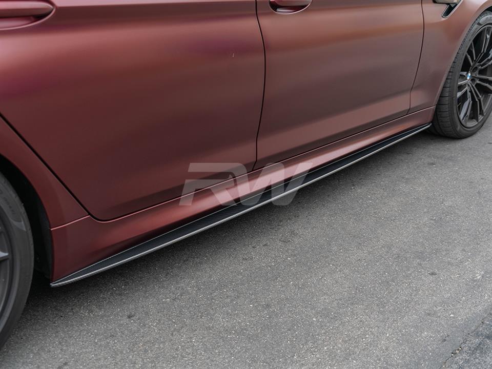 Red BMW F90 with performance style carbon fiber side skirt extensions